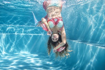 Underwater portrait against ripples of light