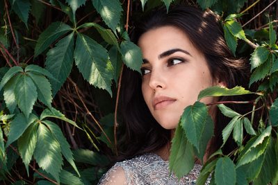 Close portrait framed by green leaves