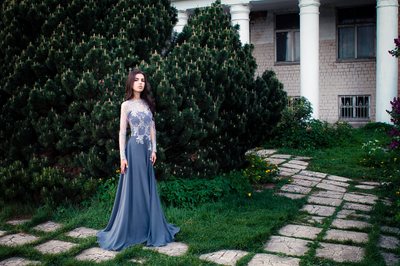 Gown against a garden path and a white house