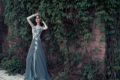 Long gown against a wall of ivy