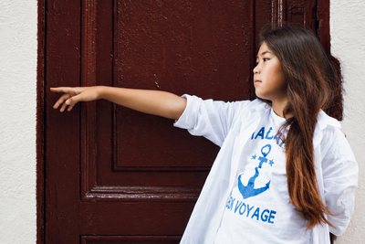 Girl in a white shirt in a doorway