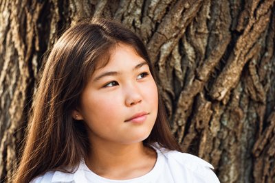 Portrait against the bark of an old tree